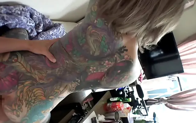 In her tiny kitchen the tension breaks with a steamy kiss and slow hands on tattooed skin