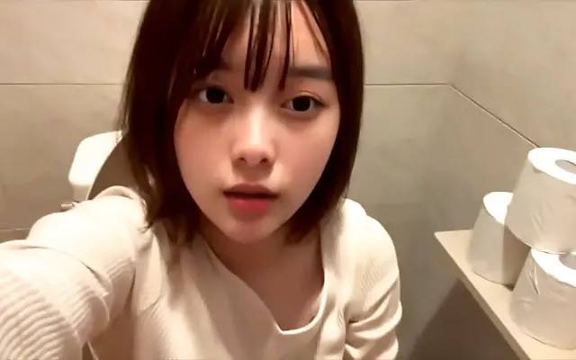 Soft pink stall walls echo moans of a Japanese amateur in public restroom bliss